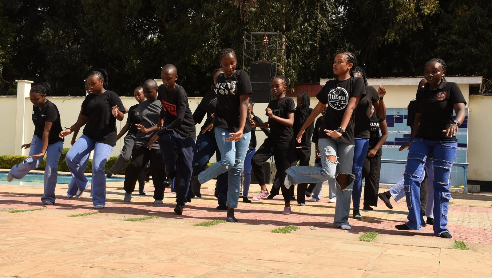 A group dance performance beside the school pool