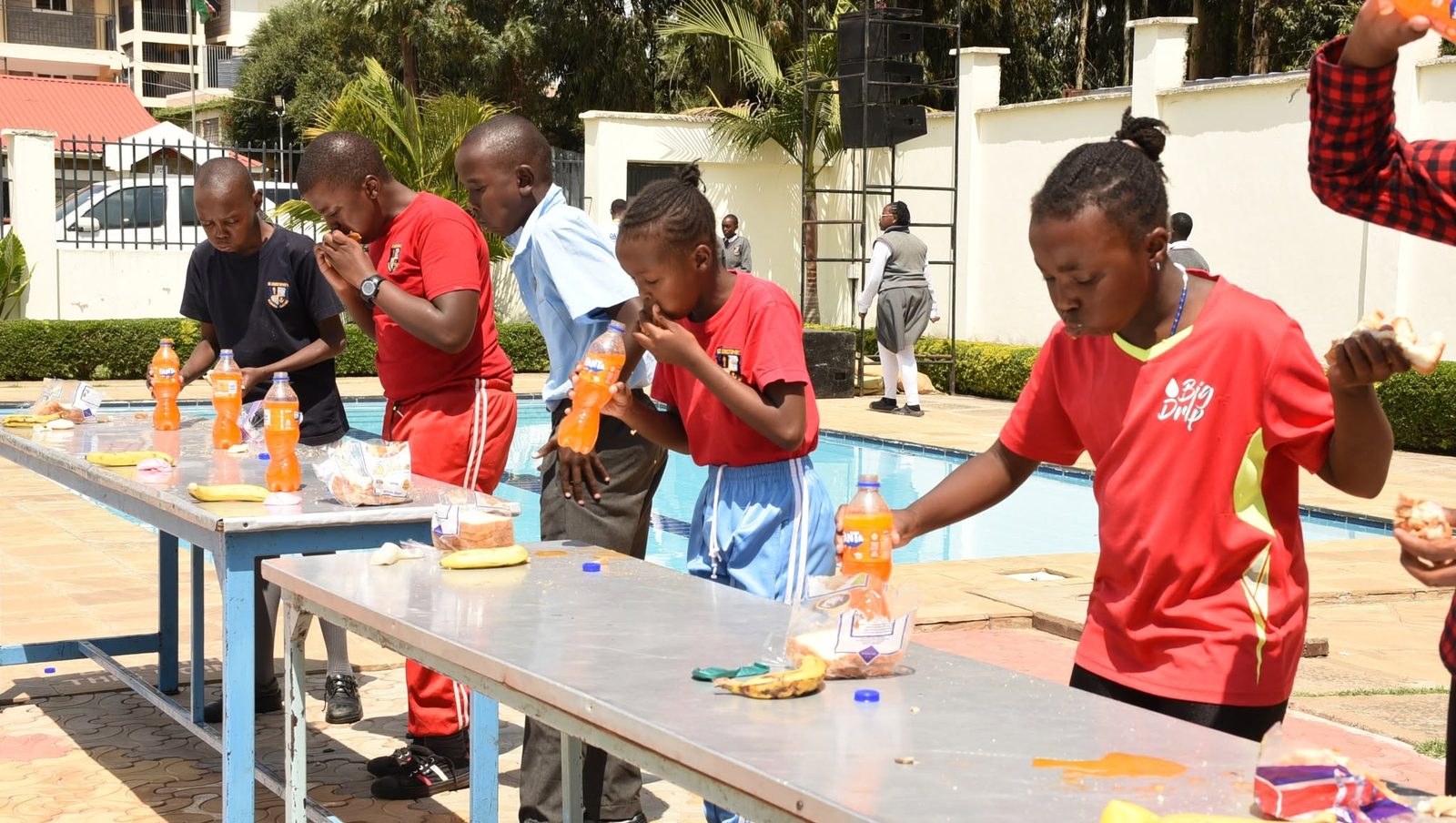Students taking part in a lighthearted eating contest at the Talent Show
